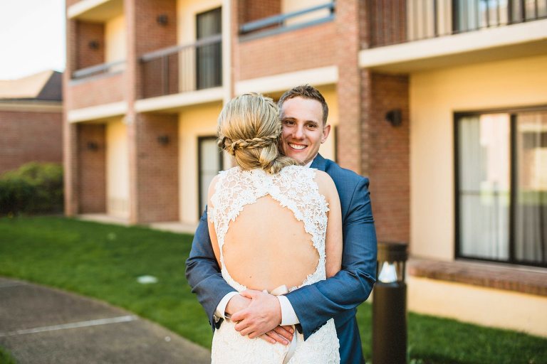 bride and groom hugging,