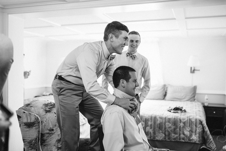 groomsmen tying bow ties,