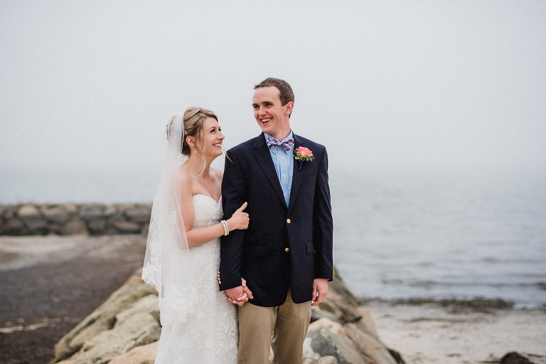 bride and groom on rocks at cape cod wedding,