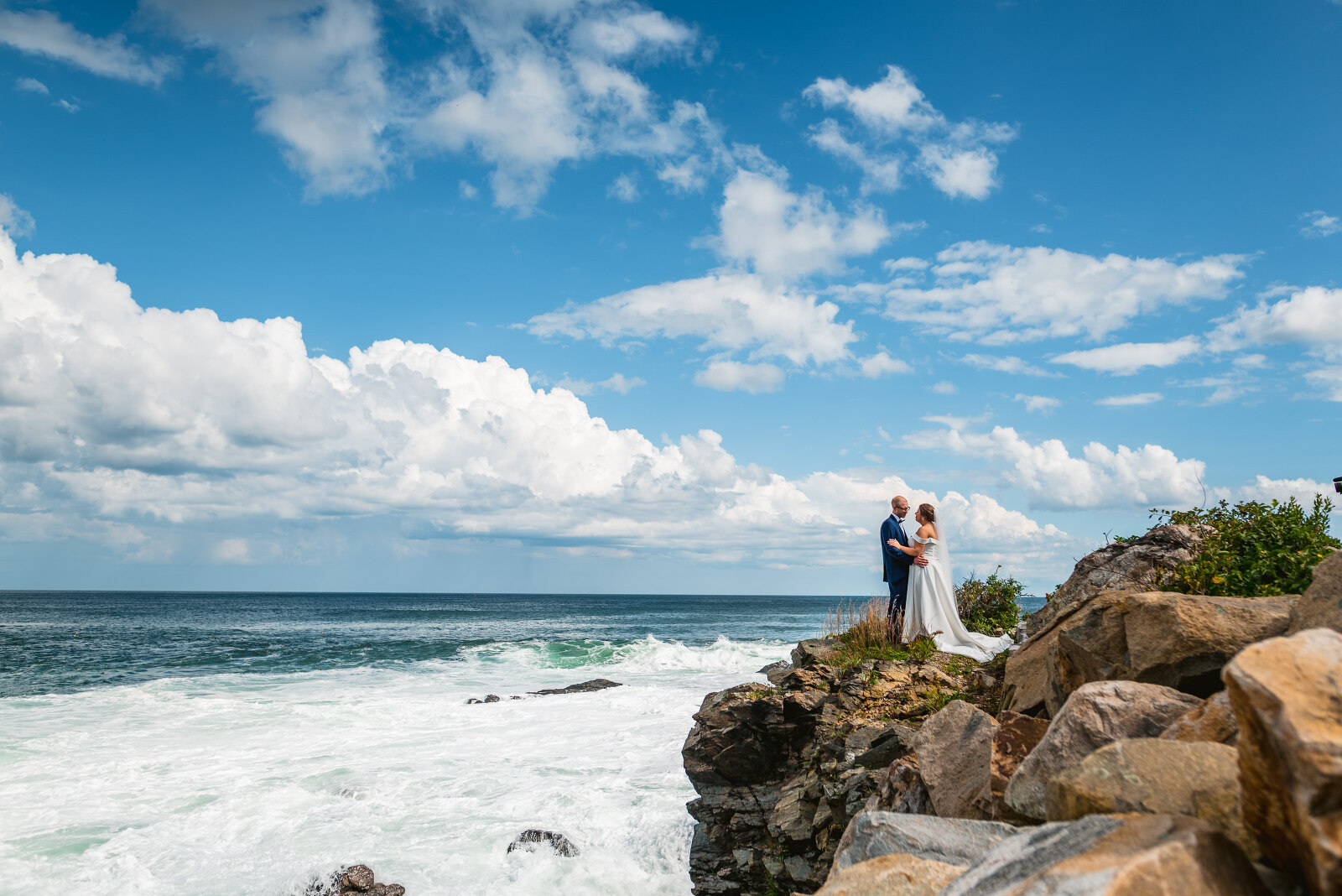 bride and groom posing on Maine coast